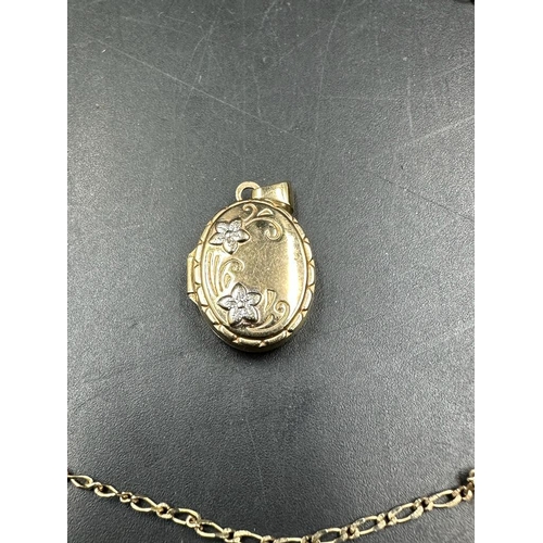 482 - A 9ct gold chain along with an oval locket (Chain weight 1.6g)