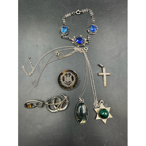 483 - A selection of silver and white metal jewellery to include necklaces, bracelet and brooches