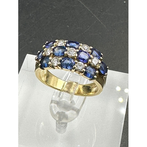 485 - A sapphire and diamond chequerboard ring on 18ct gold mount, marked 750