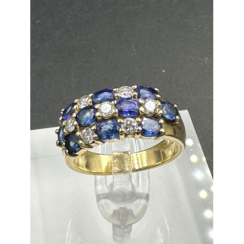 485 - A sapphire and diamond chequerboard ring on 18ct gold mount, marked 750