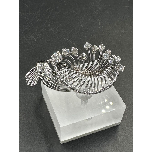 486 - A white gold diamond spray brooch with a beautiful array of quality diamonds.