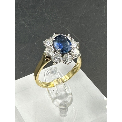 487 - A sapphire and diamond cluster ring  on an 18ct (750) shank.