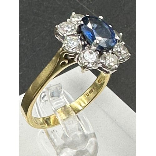 487 - A sapphire and diamond cluster ring  on an 18ct (750) shank.