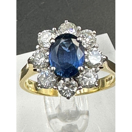 487 - A sapphire and diamond cluster ring  on an 18ct (750) shank.