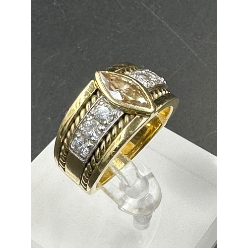 488 - A yellow gold diamond ring with central stone and three separate diamonds to each side .