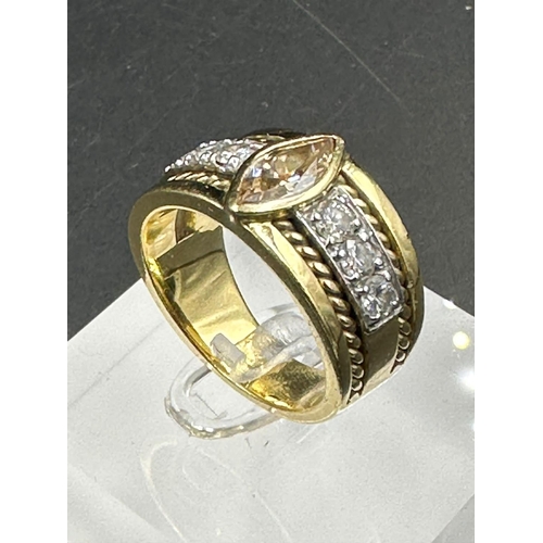 488 - A yellow gold diamond ring with central stone and three separate diamonds to each side .