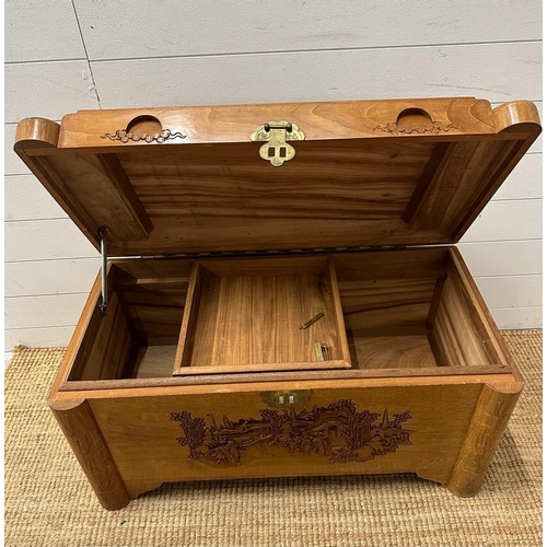 50 - A Chinese carved camphor chest with brass fittings and lock