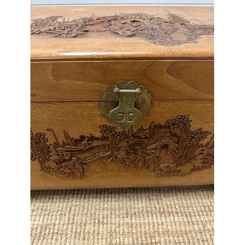 50 - A Chinese carved camphor chest with brass fittings and lock