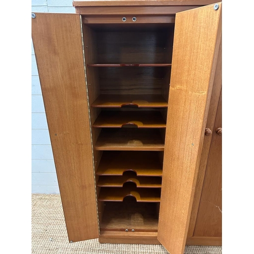 51 - A Mid Century teak Clerical cabinet comprising of three cupboards and multiple shelves (H128cm W118c... 