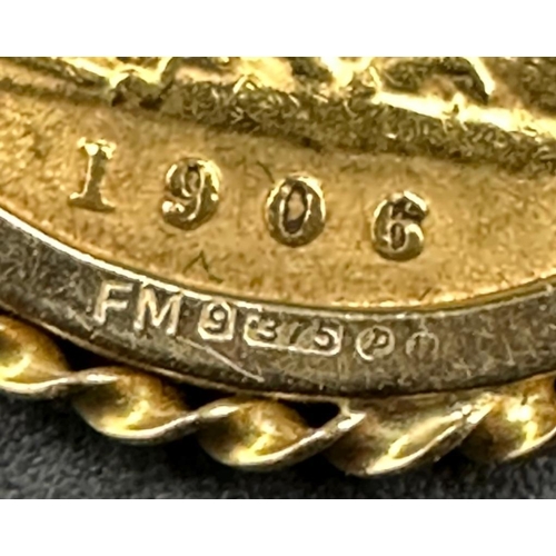 562 - A 1906 Half Sovereign on 9ct gold mount and chain. (Approximate Total Weight 7.1g)