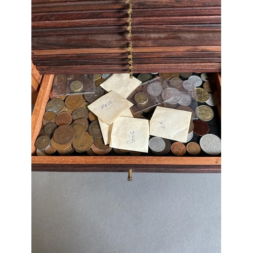 581 - A coin collectors cabinet containing a large selection of Great British coins along with worldwide c... 