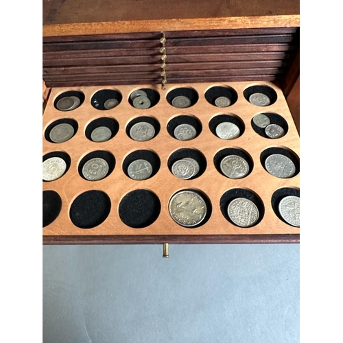 581 - A coin collectors cabinet containing a large selection of Great British coins along with worldwide c... 