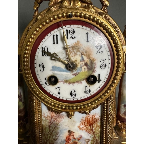 595 - A French eight day hand painted enamel faced mantel clock with garniture