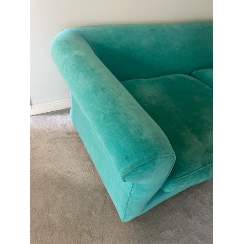 6 - An upholstered teal velvet sofa