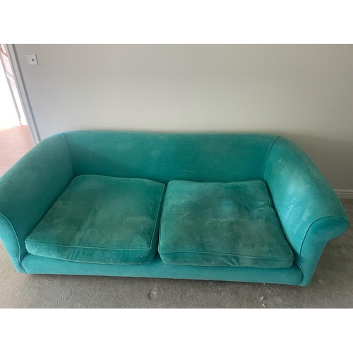 6 - An upholstered teal velvet sofa