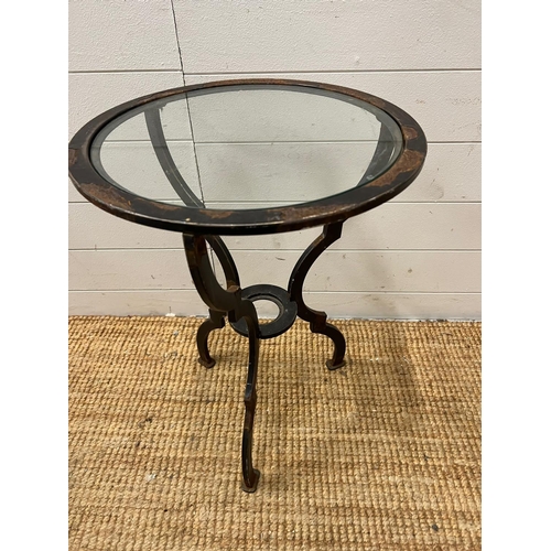 64 - A glass circular table on a metal frame (H60cm Dia44cm)