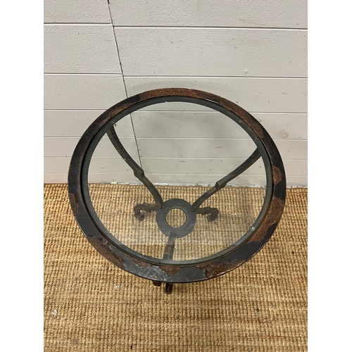 64 - A glass circular table on a metal frame (H60cm Dia44cm)