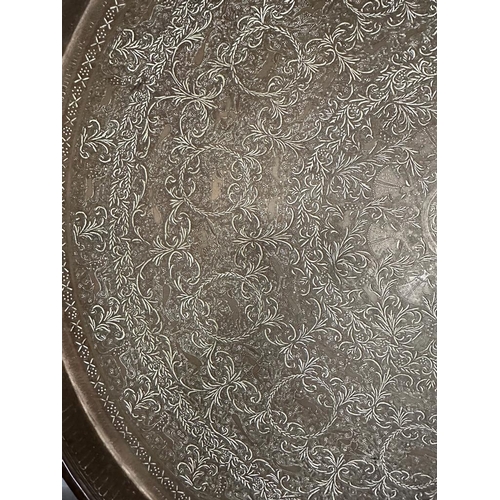 645 - A Persian brass Tea Table top engraved.