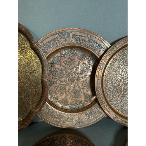 646 - A selection of six Persian and Oriental brass and copper trays.