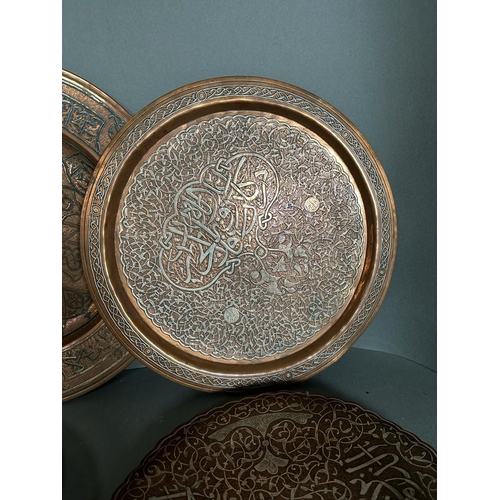 646 - A selection of six Persian and Oriental brass and copper trays.