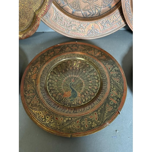 646 - A selection of six Persian and Oriental brass and copper trays.