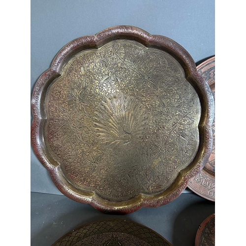 646 - A selection of six Persian and Oriental brass and copper trays.