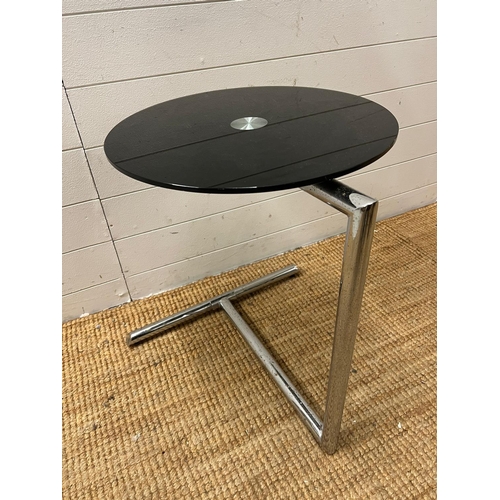 65 - A glass topped side table on chrome frame in the style of Giorgetti (H60cm Dia45cm)