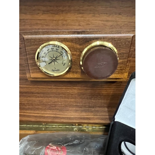 650 - A cigar humidor case along with a cutter and sixteen cigars