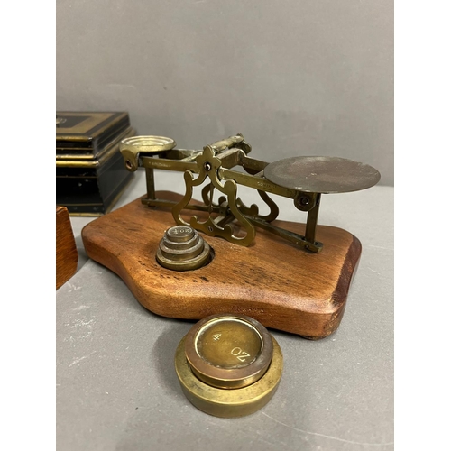 655 - A metal cashbox and a wooden desk pen holder with inkwells to end and a brass letter scales with wei... 