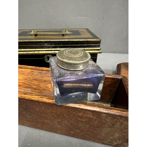 655 - A metal cashbox and a wooden desk pen holder with inkwells to end and a brass letter scales with wei... 