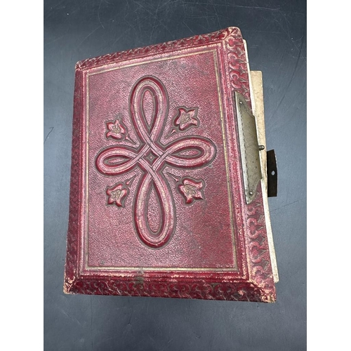 701 - A red leather Victorian photograph album with contents