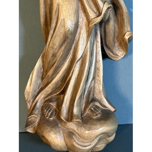 724 - A wooden carved wall hanging of the virgin mary with child