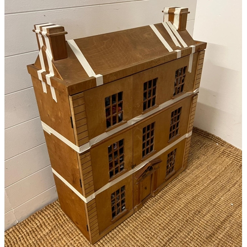 732 - A wooden town house dolls house with furniture (H85cm W67cm D25cm)