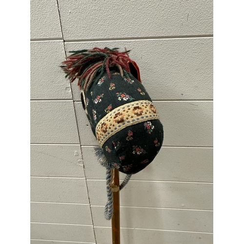 734 - A vintage hobby horse with green floral face