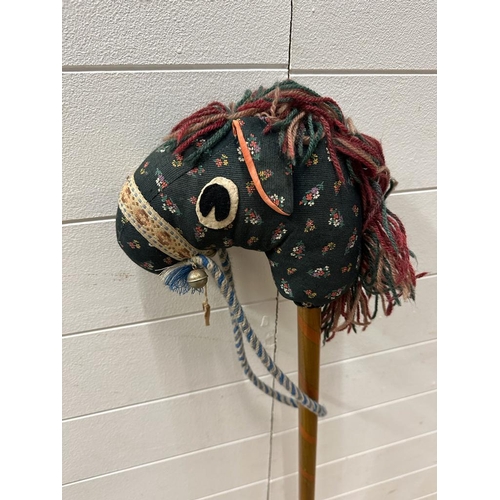 734 - A vintage hobby horse with green floral face