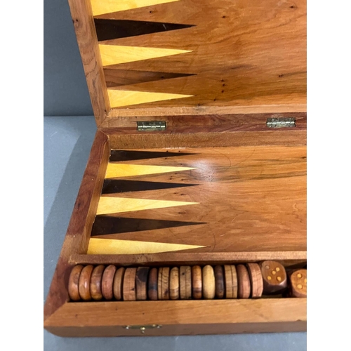 739 - A walnut style back gammon and chest set