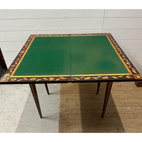 75 - A mahogany swivel top card table with floral marquetry and green baize (H74cm W84cm D43cm)