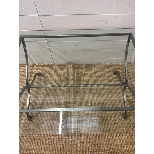 77 - A wrought iron glass topped coffee table with twisted central stretcher (H50cm W110cm D77cm)