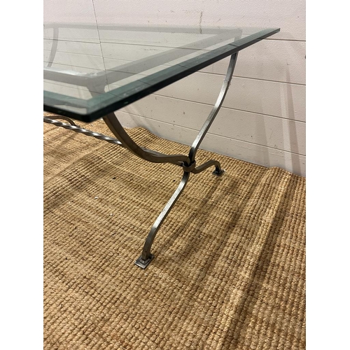 77 - A wrought iron glass topped coffee table with twisted central stretcher (H50cm W110cm D77cm)