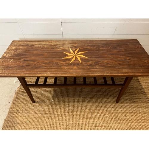 81 - A Mid Century teak coffee table with inlaid star (H46cm W124cm D48cm)