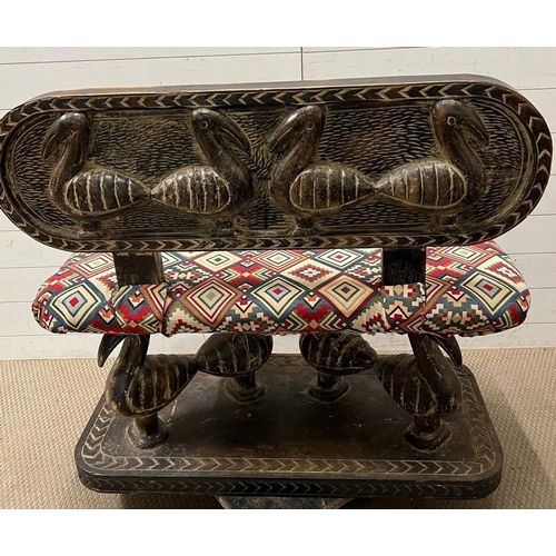 87 - A South African carved bench seat with a Kilim style, upholstered and four carved birds to back and ... 