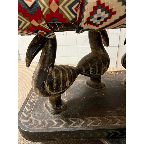 87 - A South African carved bench seat with a Kilim style, upholstered and four carved birds to back and ... 