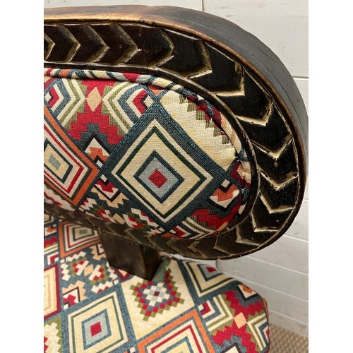 87 - A South African carved bench seat with a Kilim style, upholstered and four carved birds to back and ... 