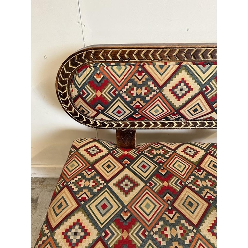 88 - A South African carved bench seat with a kilim style, upholstered and carved birds to back and base