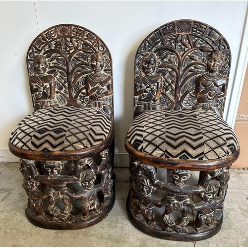 89 - A pair of carved seats with tribal theme carving to back and base