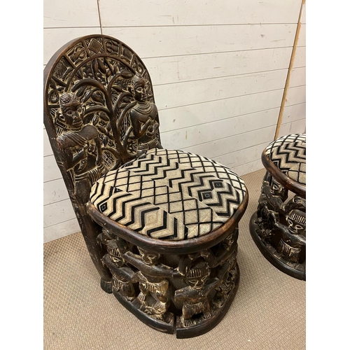 89 - A pair of carved seats with tribal theme carving to back and base