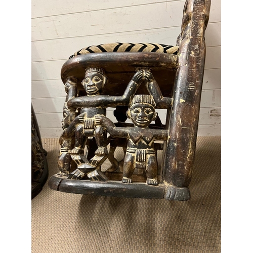 89 - A pair of carved seats with tribal theme carving to back and base