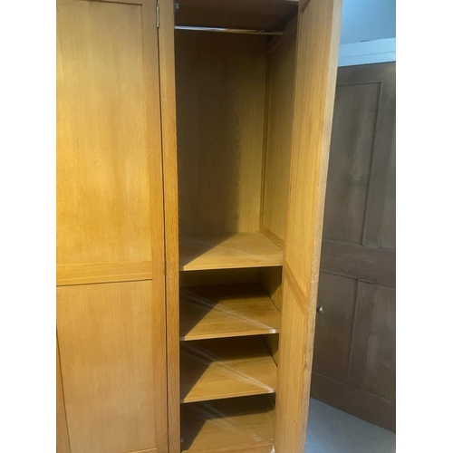 9 - A light oak triple wardrobe (H222cm W162cm D60cm)