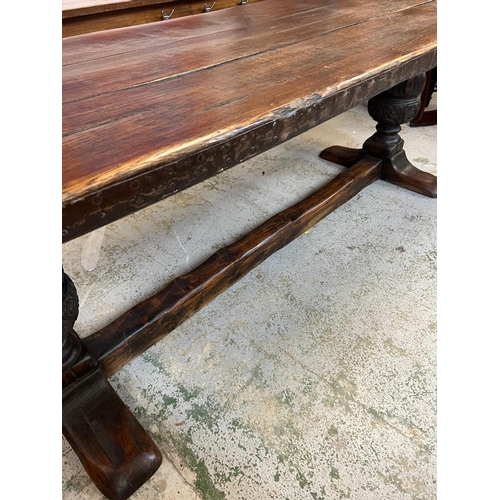 96 - An Elizabethan jointed oak refectory table with three plank top on baluster legs and stretchers (82c... 