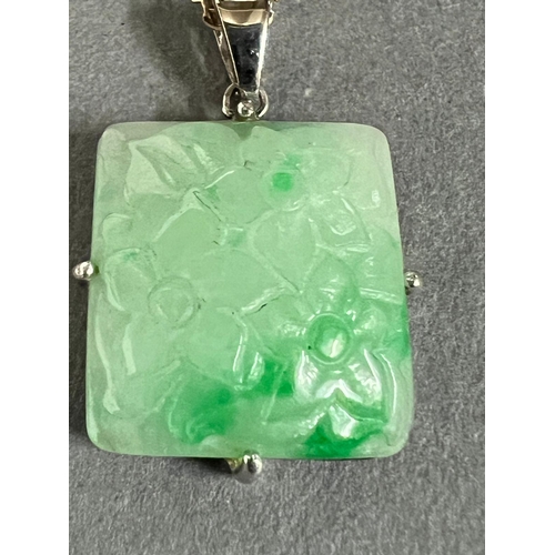 460A - A square jade pendant on a 9ct gold necklace.